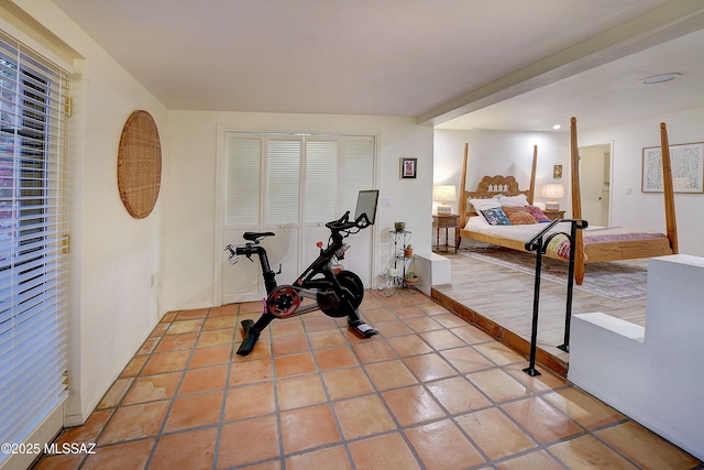 exercise area featuring light tile patterned floors