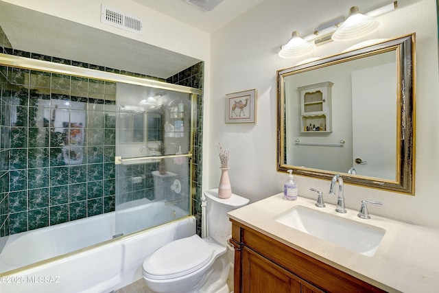 bathroom with toilet, enclosed tub / shower combo, visible vents, and vanity