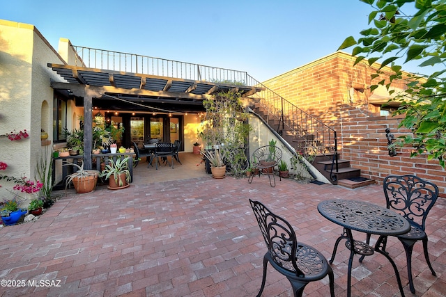 view of patio / terrace with outdoor dining space and stairway