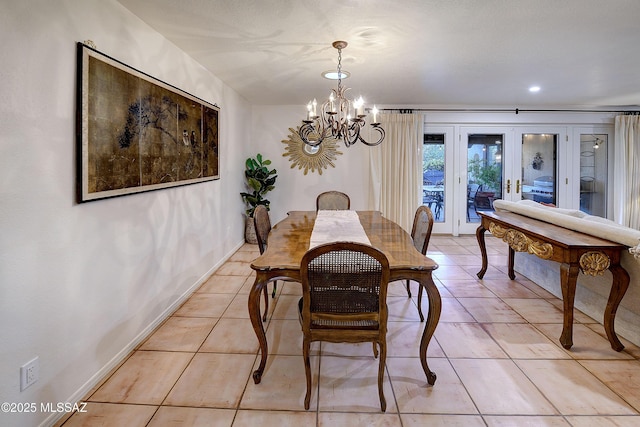 dining space featuring light tile patterned floors, baseboards, and a notable chandelier