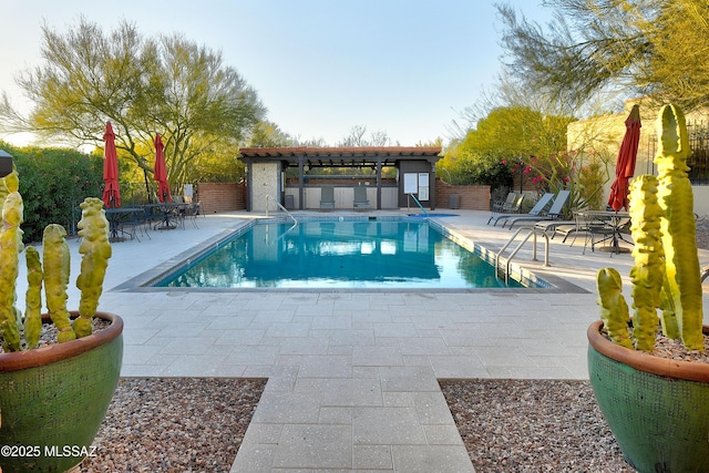 community pool featuring a patio area and fence