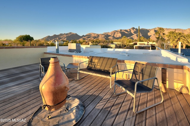 wooden deck with a mountain view and outdoor dry bar