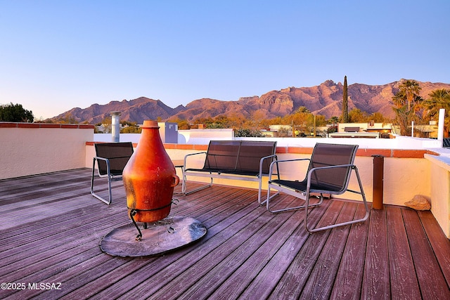 wooden terrace with a mountain view and area for grilling