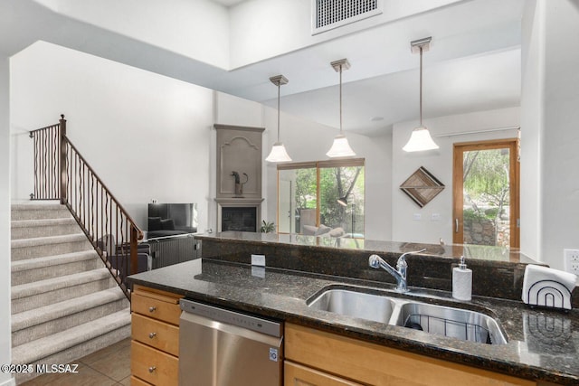 kitchen with dishwasher, a wealth of natural light, a sink, and visible vents