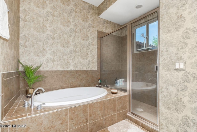 bathroom with wallpapered walls, a garden tub, and a stall shower