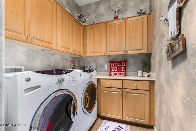 washroom with cabinet space and separate washer and dryer