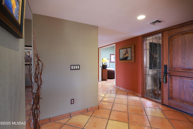 entrance foyer with light tile patterned floors, baseboards, visible vents, and recessed lighting