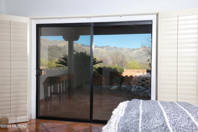 bedroom with tile patterned flooring and a mountain view