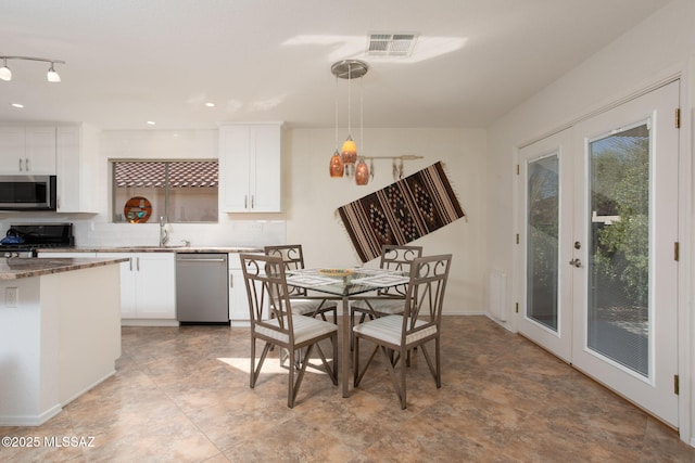 dining space with french doors and visible vents