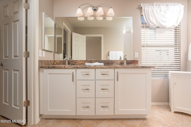 full bath featuring tile patterned floors, a sink, and double vanity