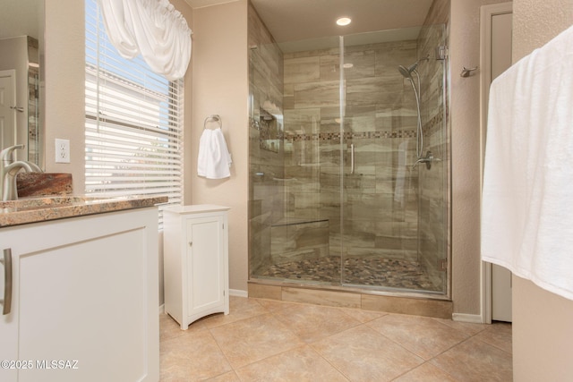 full bathroom with a stall shower and tile patterned floors