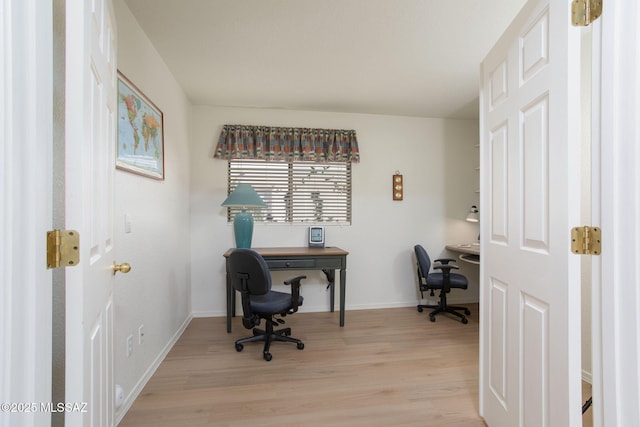 office area featuring light wood finished floors and baseboards