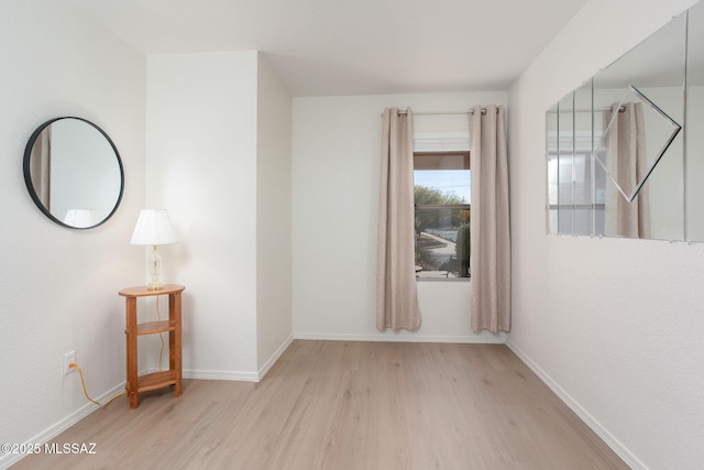 unfurnished room featuring light wood-style floors and baseboards