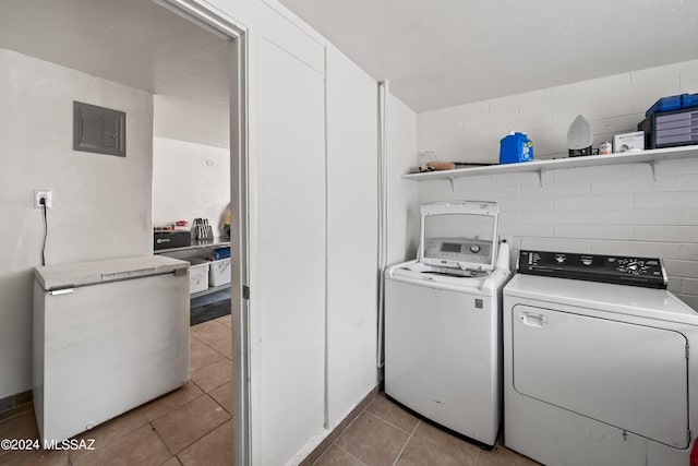 clothes washing area featuring laundry area, electric panel, independent washer and dryer, and light tile patterned flooring