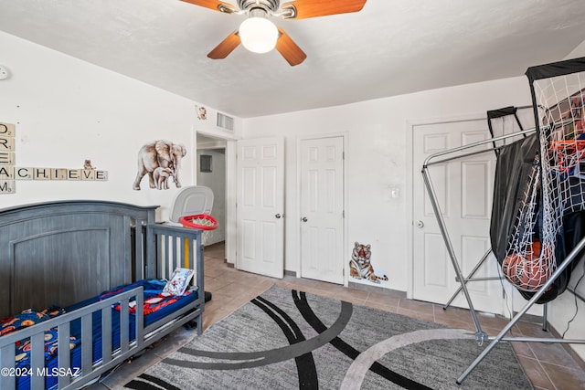 bedroom with visible vents, ceiling fan, and tile patterned floors