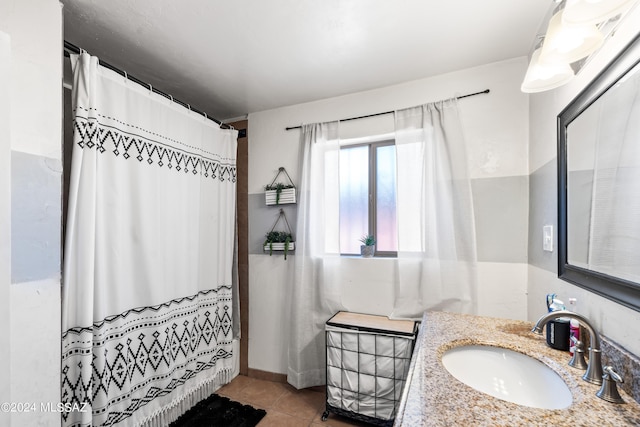 bathroom featuring curtained shower, vanity, and tile patterned floors