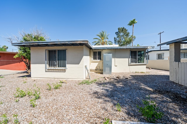 back of house featuring fence