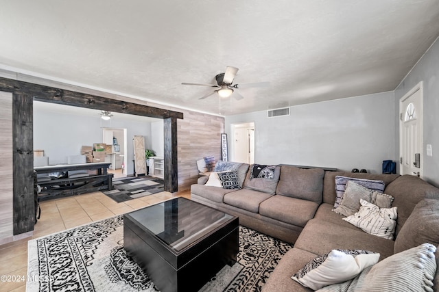 living area with light tile patterned floors, ceiling fan, and visible vents