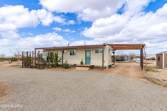 view of front of property featuring a carport and driveway