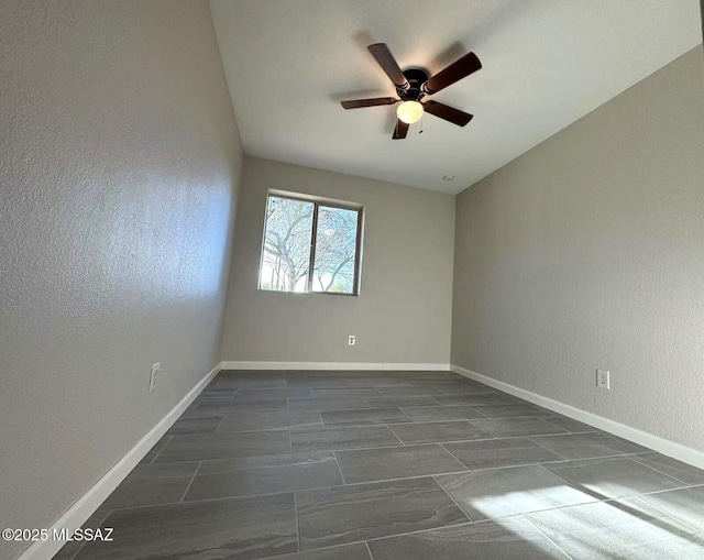 unfurnished room featuring baseboards and a ceiling fan