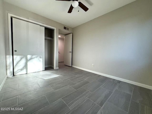 unfurnished bedroom with baseboards, visible vents, and a closet