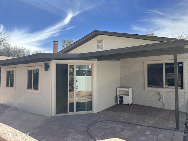 back of house featuring a patio and stucco siding