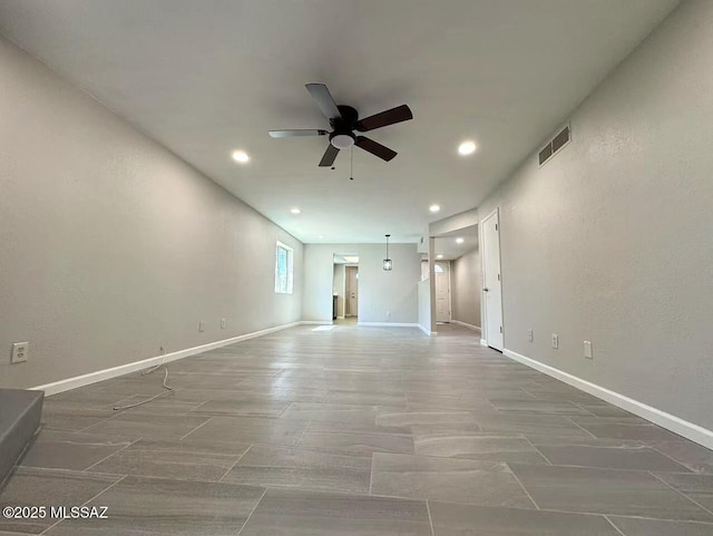 unfurnished living room with recessed lighting, visible vents, ceiling fan, and baseboards