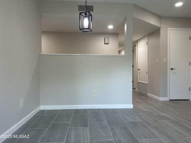 unfurnished room featuring recessed lighting, visible vents, and baseboards