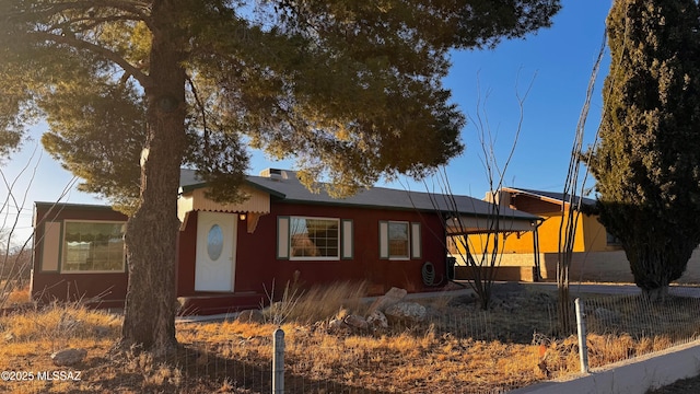 ranch-style home with fence