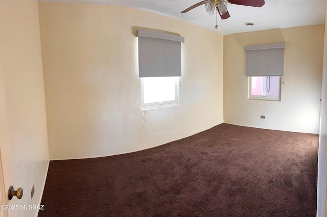 spare room with carpet floors, ceiling fan, and visible vents