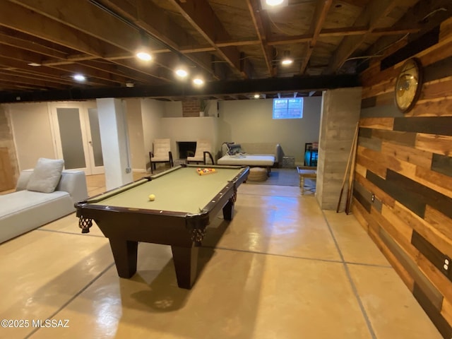 recreation room featuring wood walls, billiards, and finished concrete floors