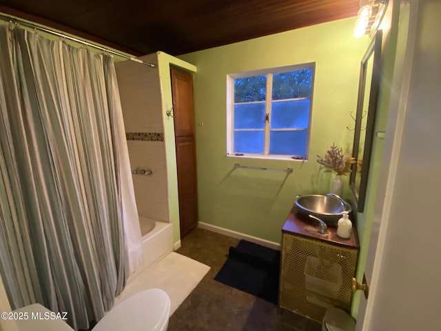 bathroom with shower / bath combo, baseboards, vanity, and toilet