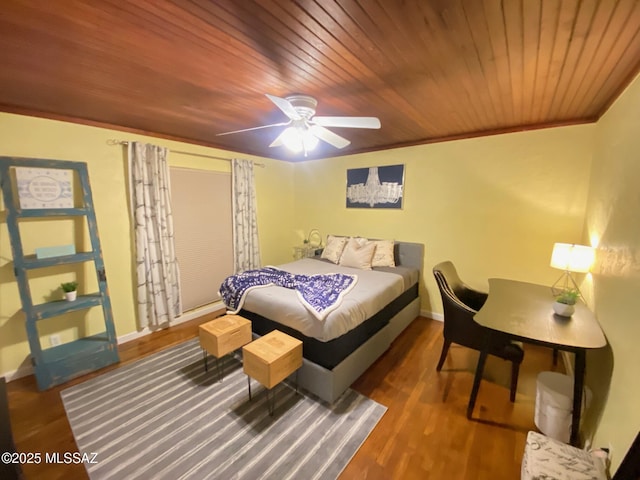 bedroom with wooden ceiling, crown molding, baseboards, and wood finished floors