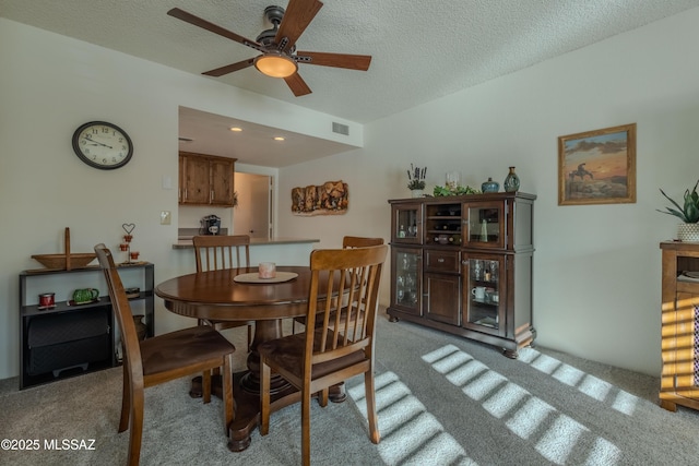 dining space with a textured ceiling, recessed lighting, a ceiling fan, visible vents, and carpet