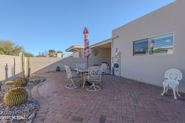 view of patio with outdoor dining area and a fenced backyard