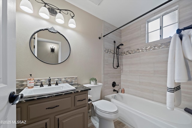 full bathroom featuring toilet, tasteful backsplash,  shower combination, and vanity