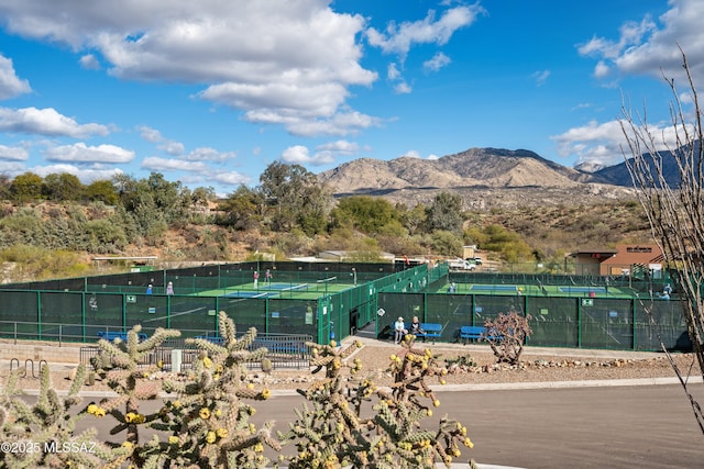 exterior space featuring fence and a mountain view