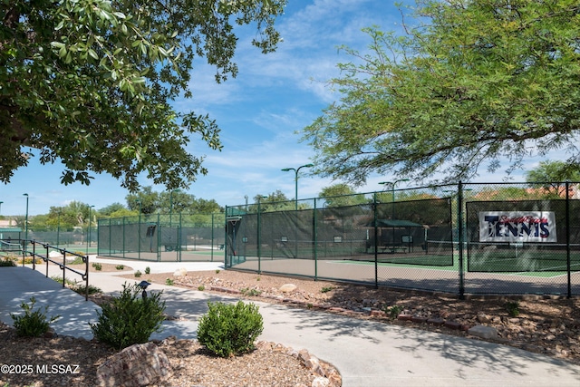 view of sport court featuring fence