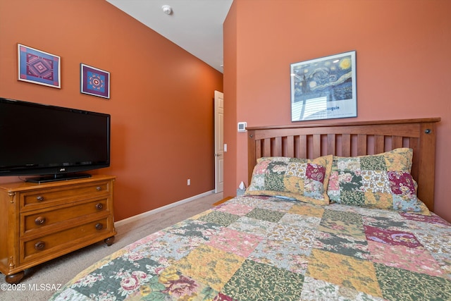 bedroom featuring light colored carpet and baseboards