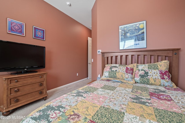 bedroom with baseboards and light colored carpet