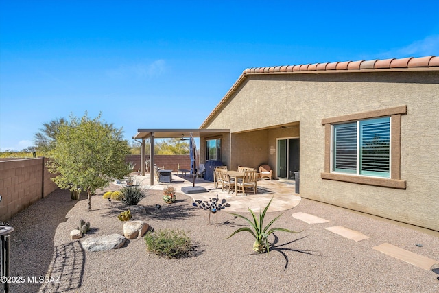 back of property with a fenced backyard, a patio, and stucco siding