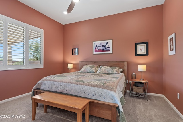 carpeted bedroom with baseboards and a ceiling fan