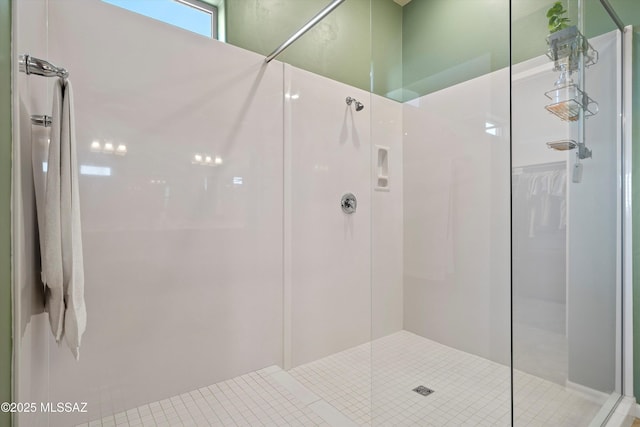 bathroom featuring walk in shower and tile patterned floors