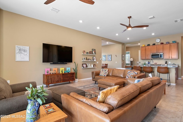 living area with ceiling fan, visible vents, and recessed lighting
