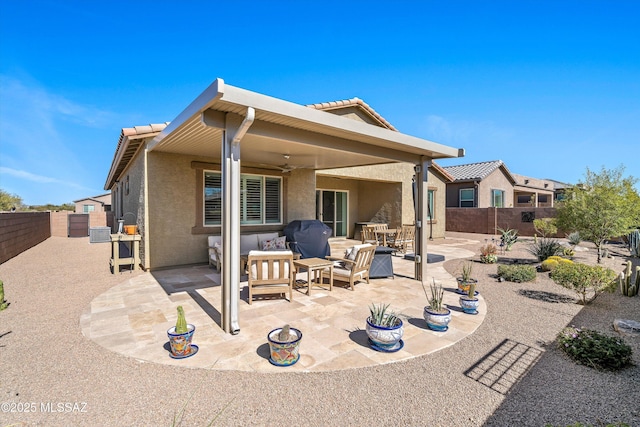 back of house featuring a patio, stucco siding, a ceiling fan, a fenced backyard, and a tiled roof