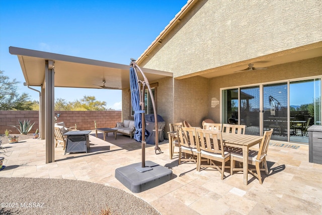 view of patio / terrace with an outdoor hangout area, fence, outdoor dining space, and a ceiling fan