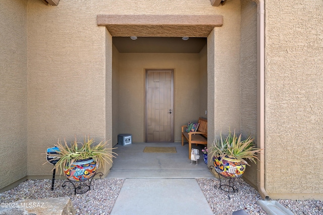 view of exterior entry featuring stucco siding