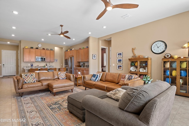 living room with light tile patterned floors, visible vents, a ceiling fan, and recessed lighting