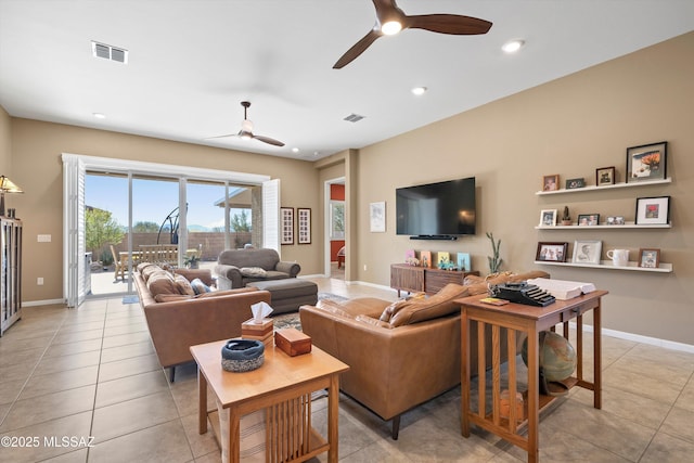 living room featuring visible vents, ceiling fan, and light tile patterned floors