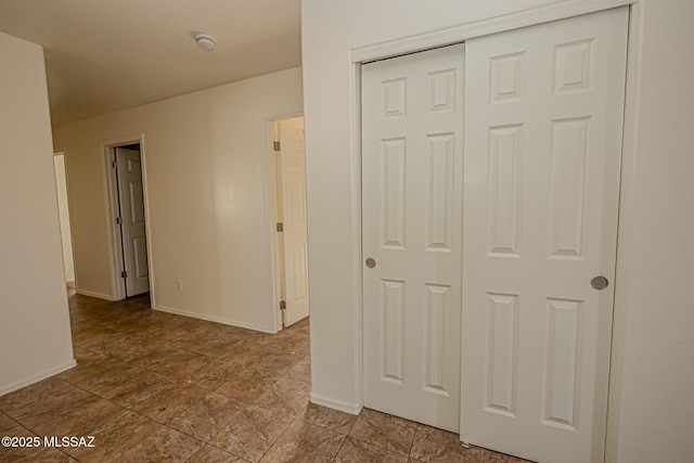 interior space featuring baseboards and a closet